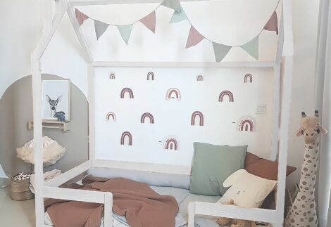 Bed like a thin wooden house with a fence