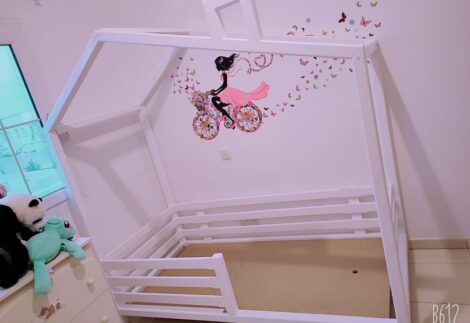 Kid's bed has a ground house structure with a fence