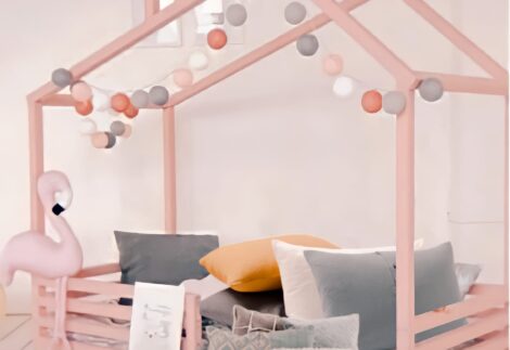 Kid's bed has a ground house structure with a fence
