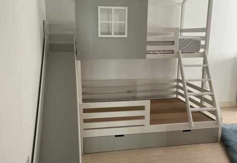 Bunk bed has two different sizes, like the house shape.