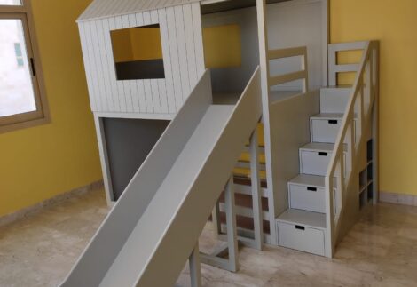 House-shaped bunk bed with a large slide