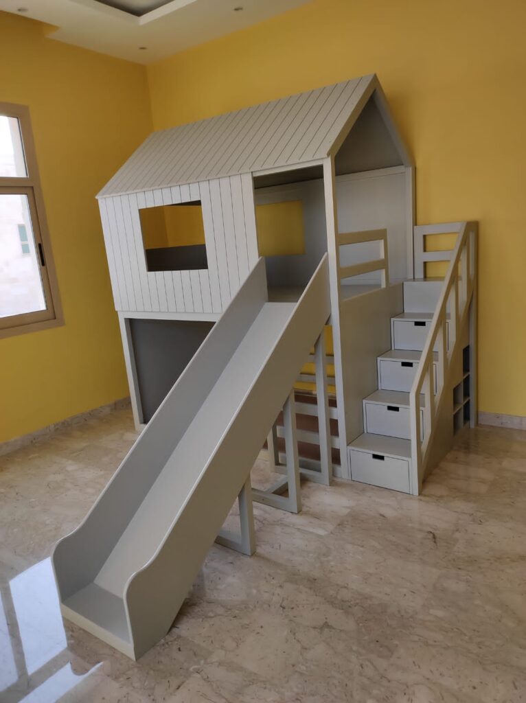 House-shaped bunk bed with a large slide