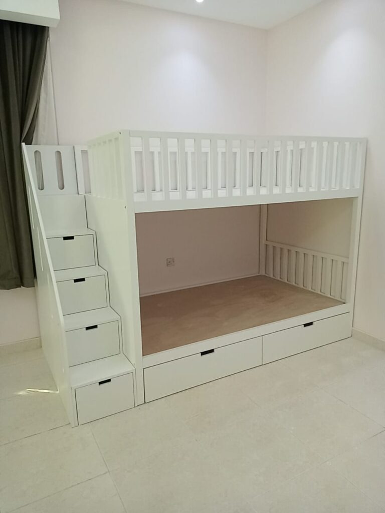 Bunk bed with railings at the top