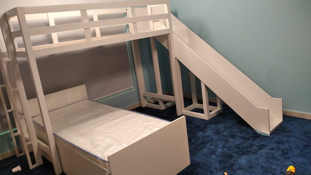 Two bunk beds in two different directions and a slide