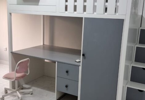 Railing loft bed with side drawer and desk below with wardrobe
