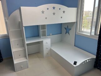 Two beds, a desk and a side stair with drawers