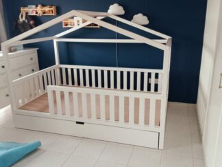 Bed with guardrails and storage drawer underneath, and has a wooden top like a cottage