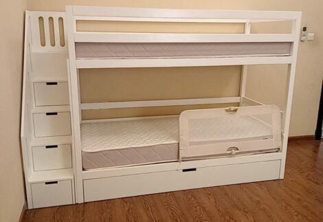 Bunk bed with storage drawers under the stairs and a lower drawer under the bed