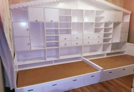 Two beds with large side storage shelves