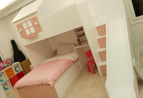 cottage style bed with window at top, desk at bottom, side stairs and slide
