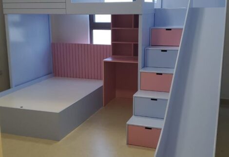 cottage style bed with window at top, desk at bottom, side stairs and slide