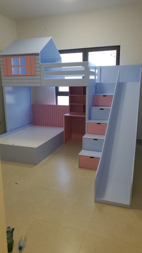 cottage style bed with window at top, desk at bottom, side stairs and slide